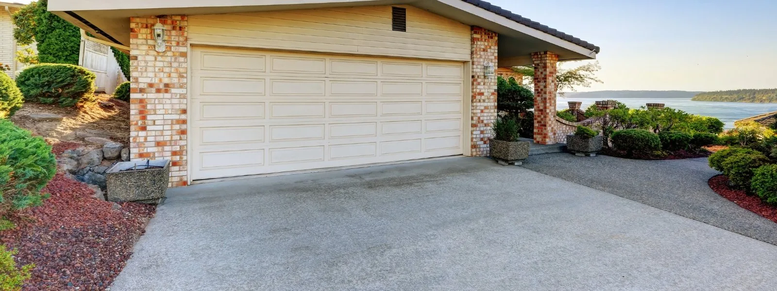 Concrete driveway alongside a landscaped garden